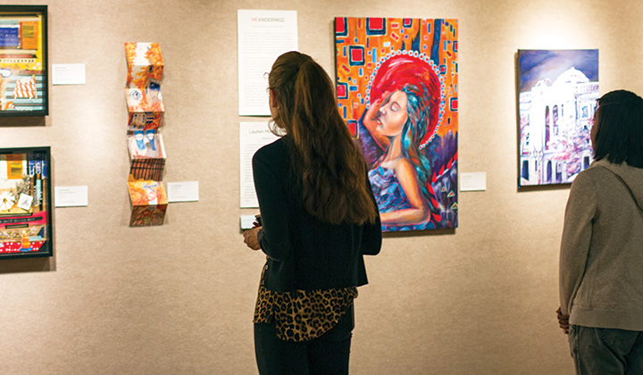 Person looking at art display on a gallery wall